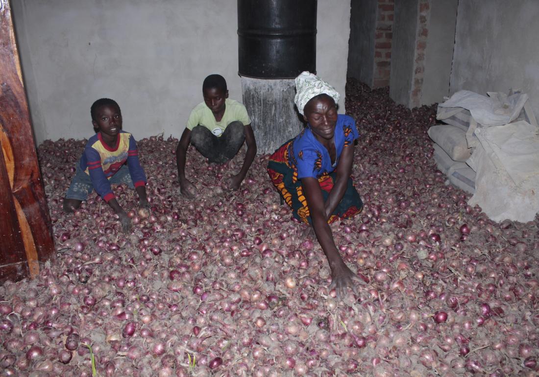   Christine with two of her sons sorting out onions