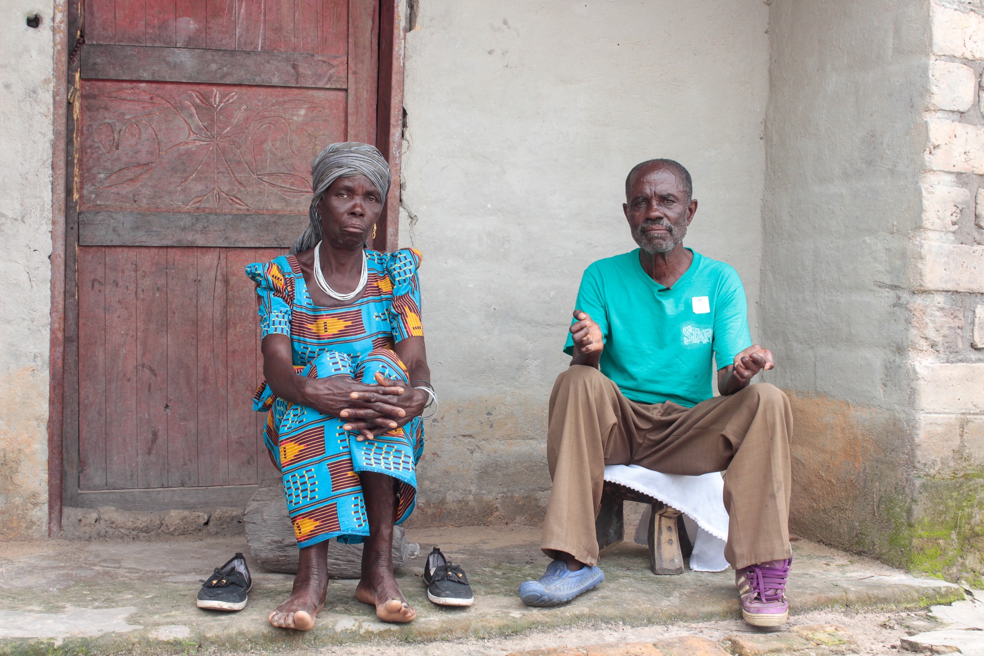 Stephen Kampapa village headman and his wife Apwina kampapa. sitting outside their home they were among the first people to be relocated here in 1988