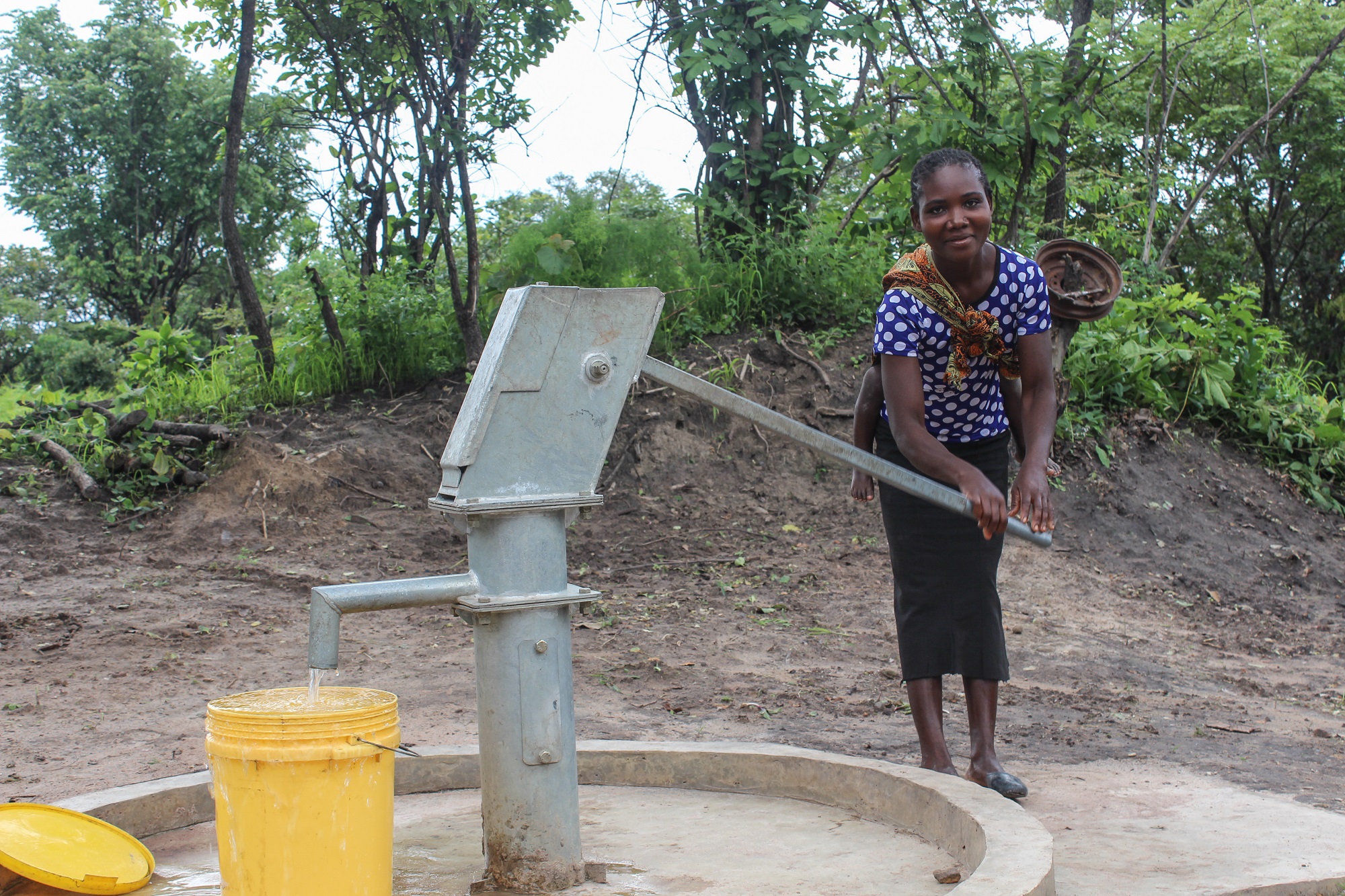 bwalya Musonda drinking water at the newly drilled borehole in kampapa village