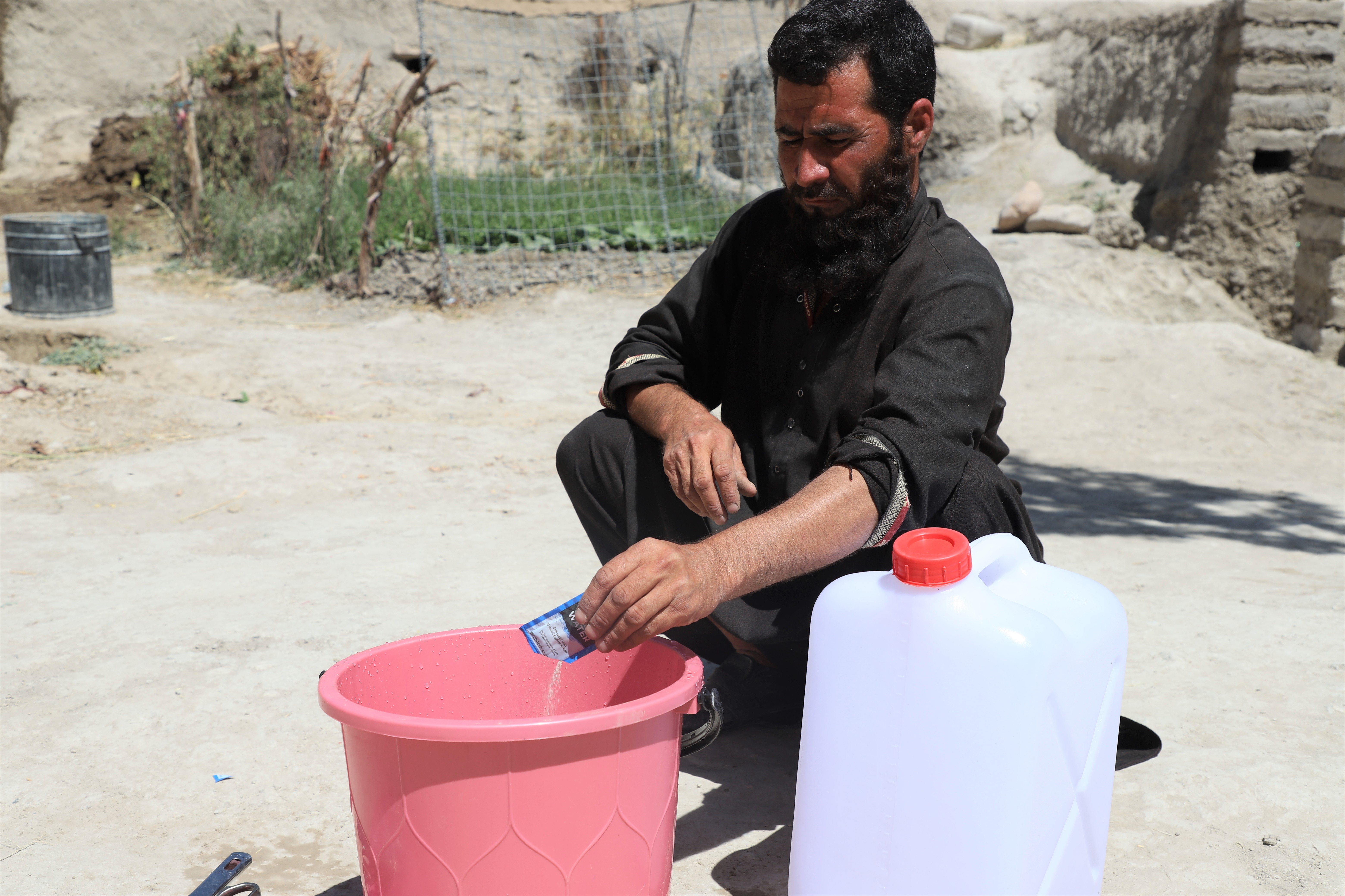 Ghani is using P&G packet  for water purification. 