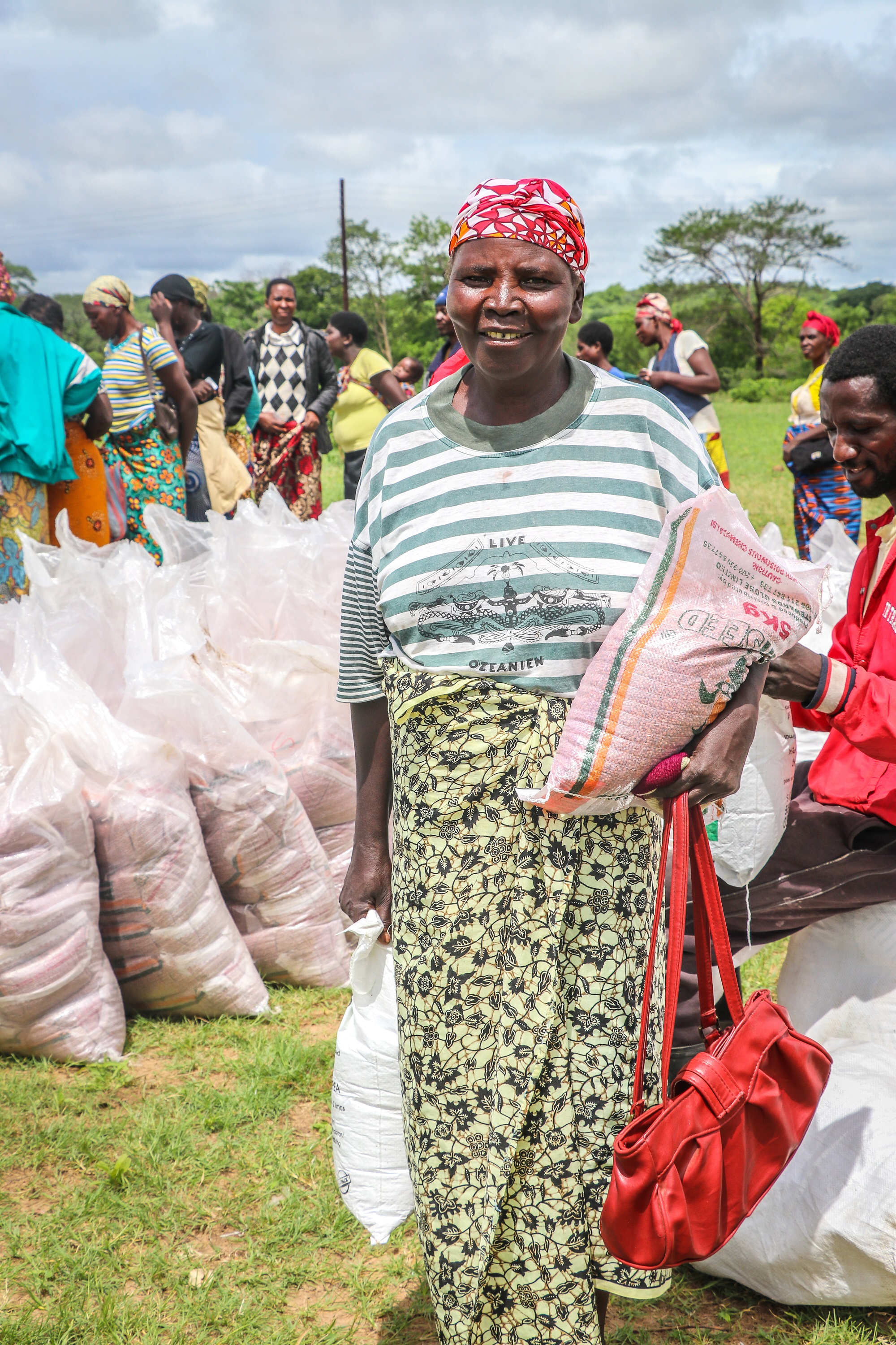 Josephine at a food and seed distribution point with her ration