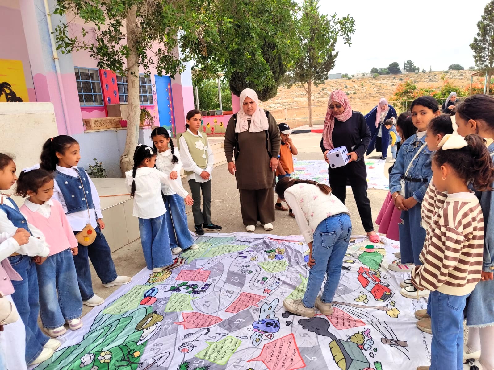 A group of Palestinian students are taking part in a game promoting the protection of the environment in the West Bank