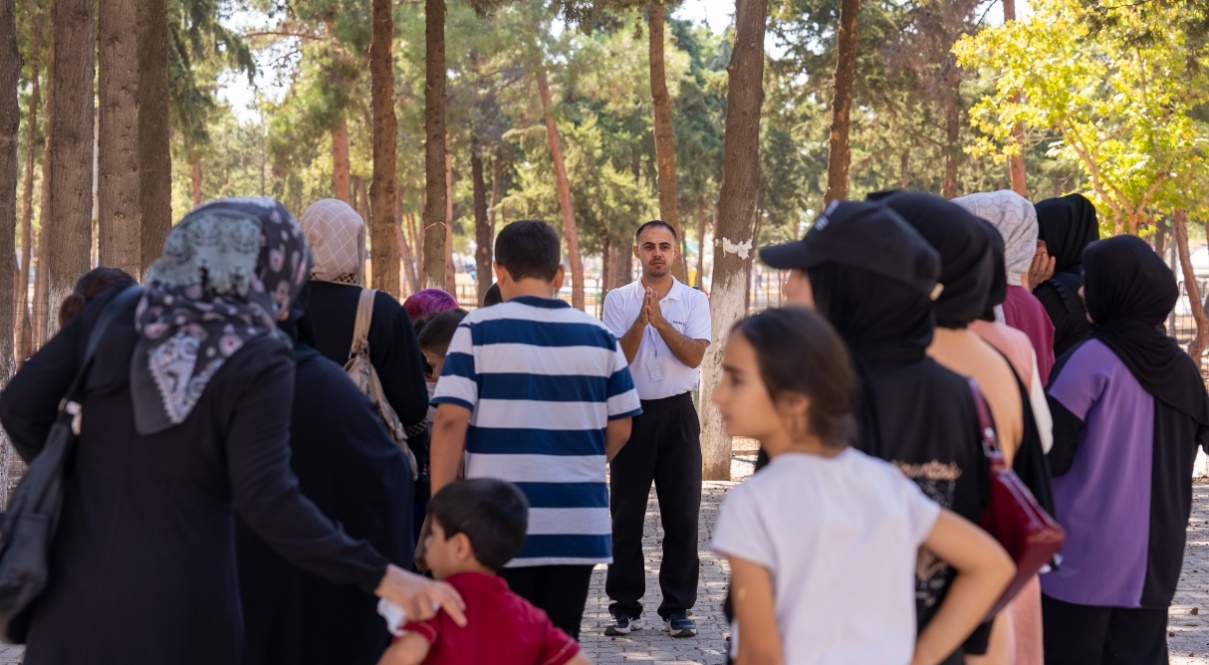 Caregivers and their children gather in the yard of the Kilis LIFT Center, preparing together for a choreographed activity—a moment of shared joy, movement, and connection.— Samer Asaid, World Vision Syria Response Partner