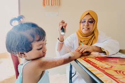 A child diagnosed with Tinea Corporis getting inspected
