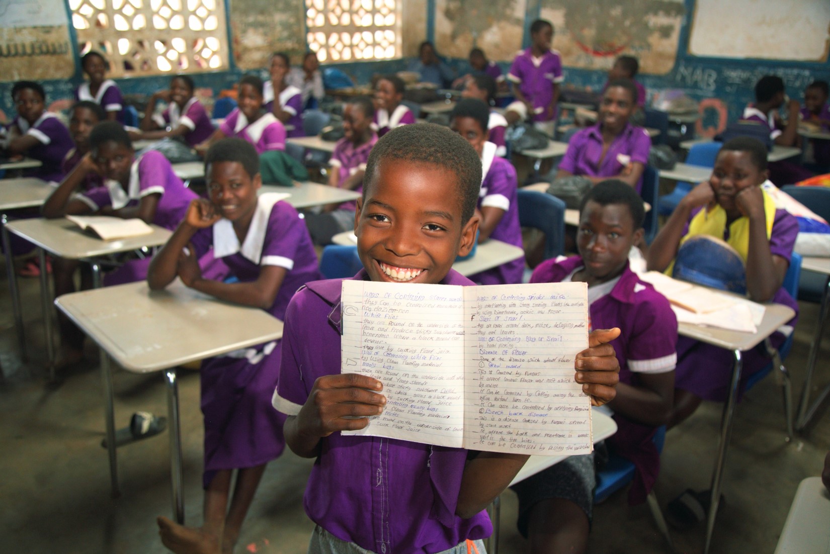 Kagunje Primary School learner showing the improved handwriting due to availability of desks.