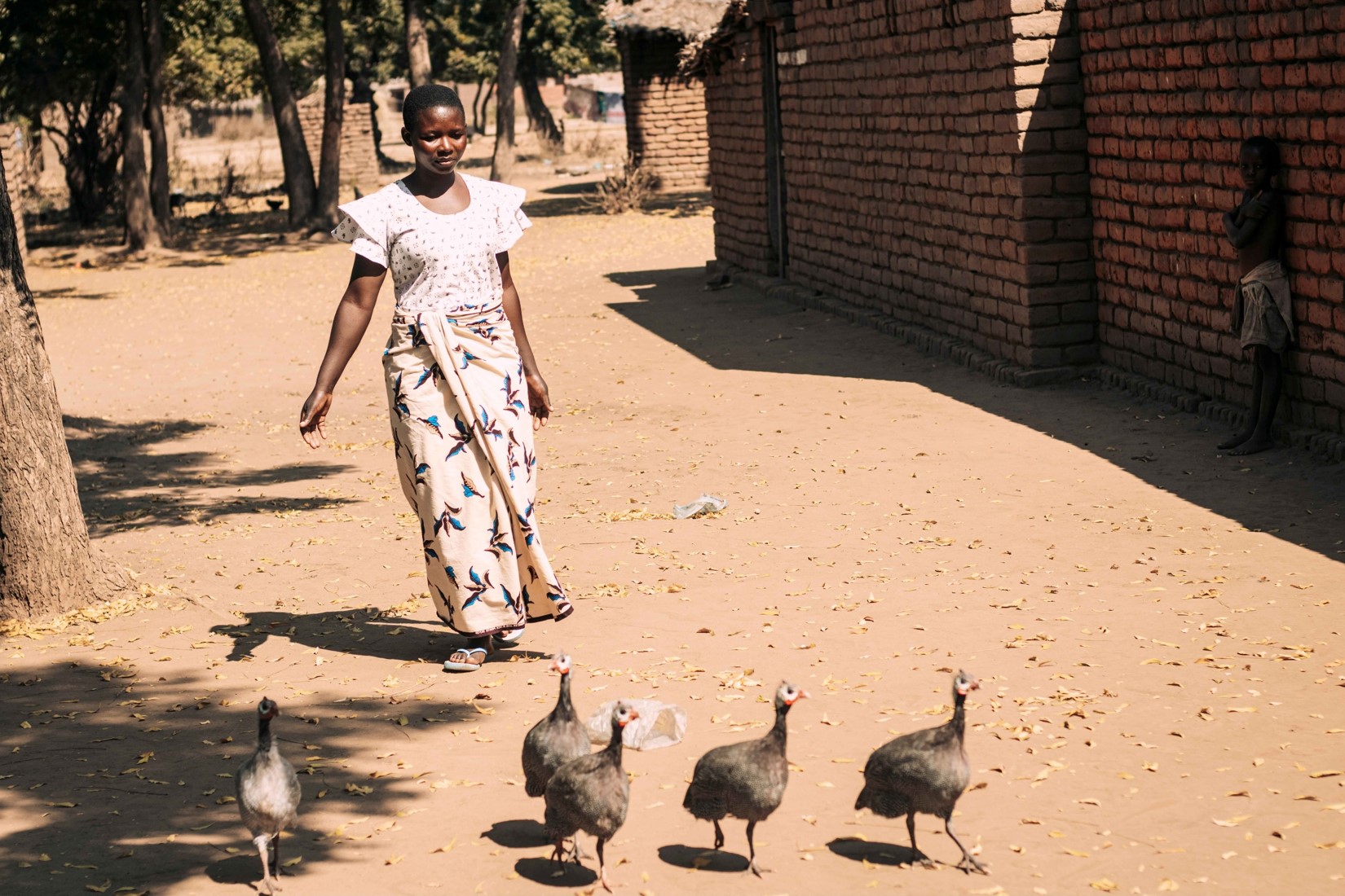 Watson inspecting her guinea fowls, a key part of her poultry farming venture.