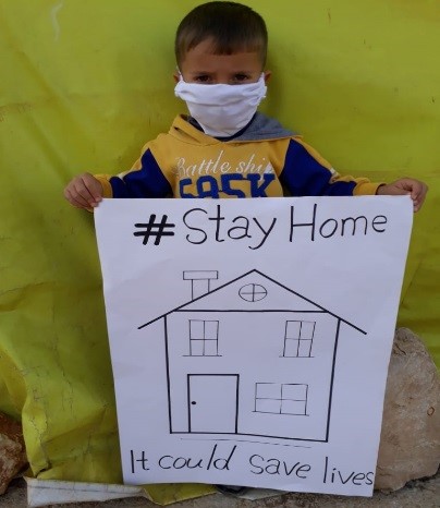 Child holding a sign board