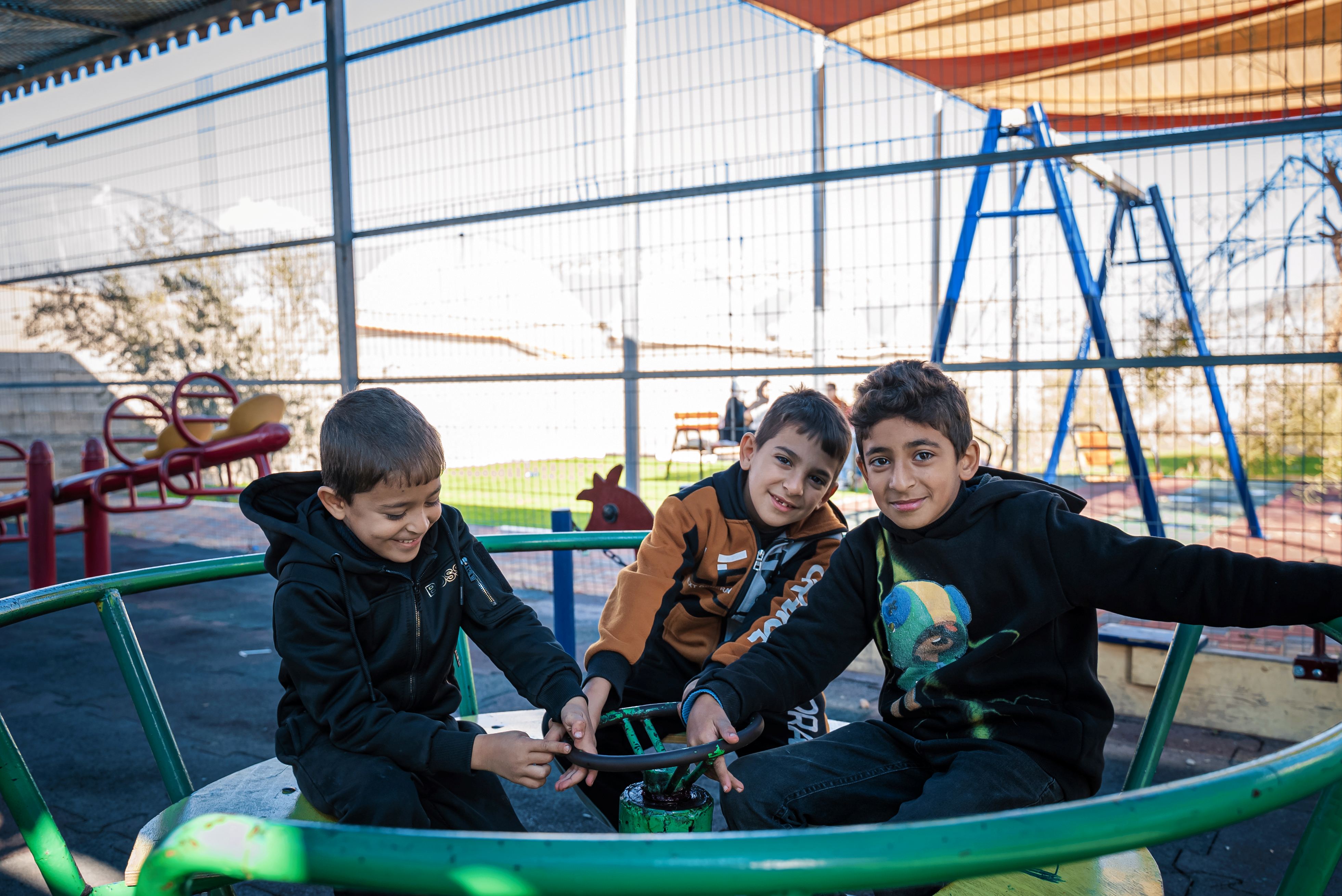 Children are playing in the newly installed material. 