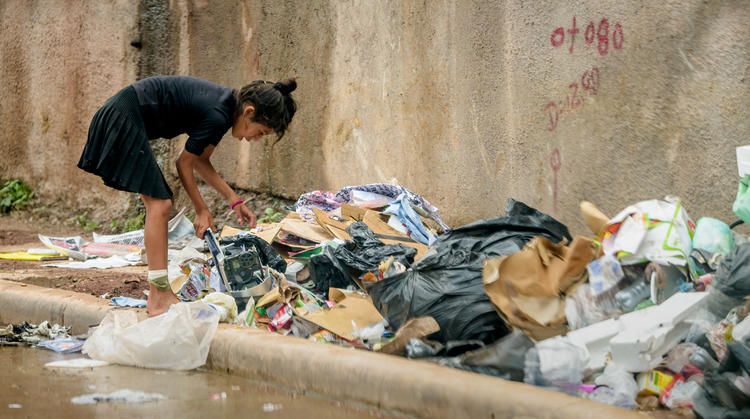 Girl sifting through plastic waste