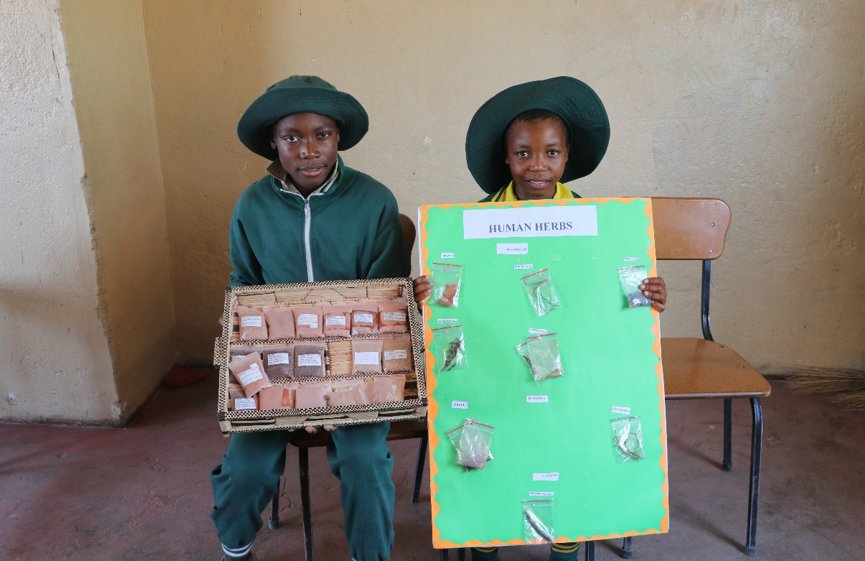 Sandile (left) and her friend with the herbs that they also made