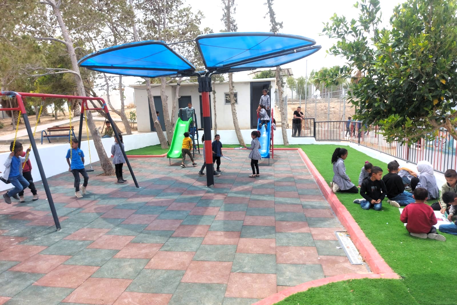 The new playground is situated close t the school of the village.