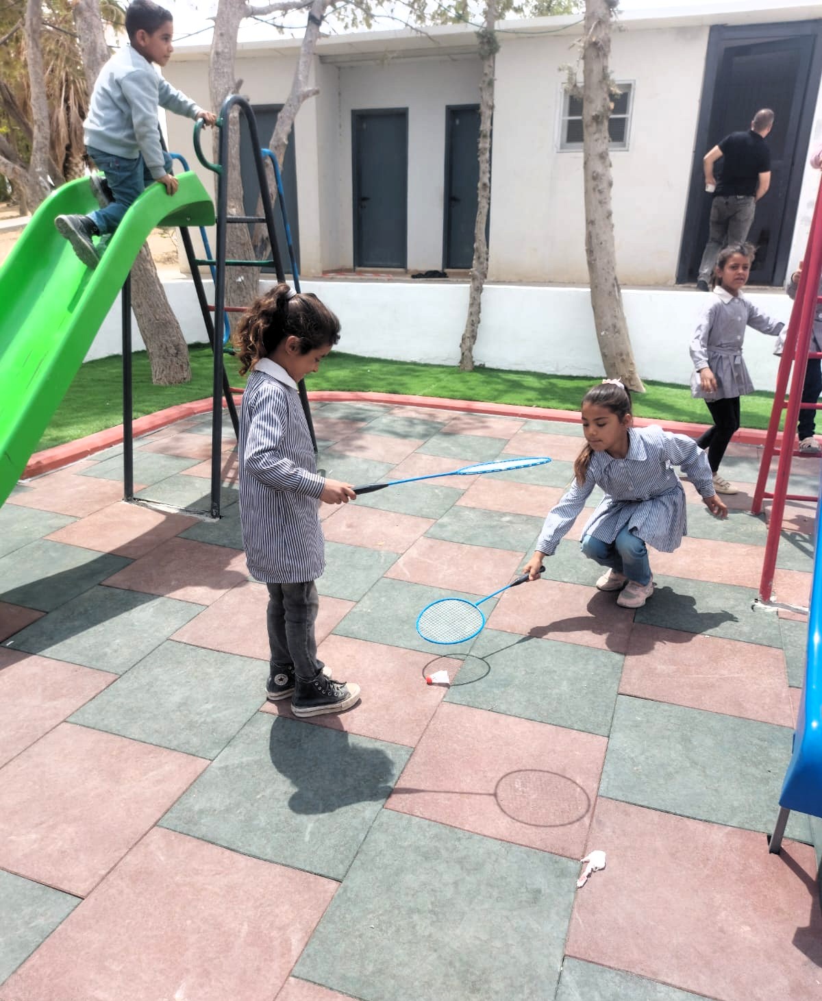 Palestinian children play in the new playground