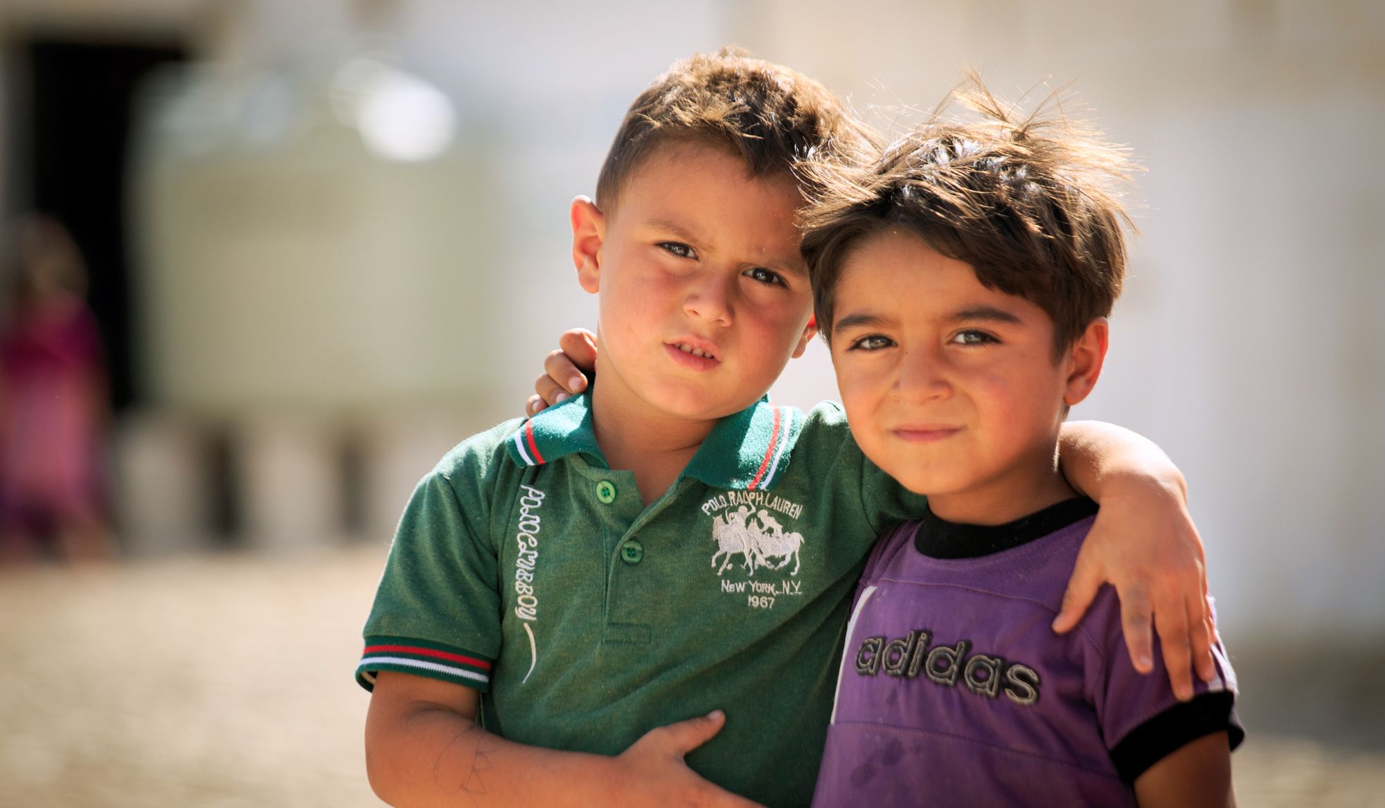 <alt="Two boys embracing">