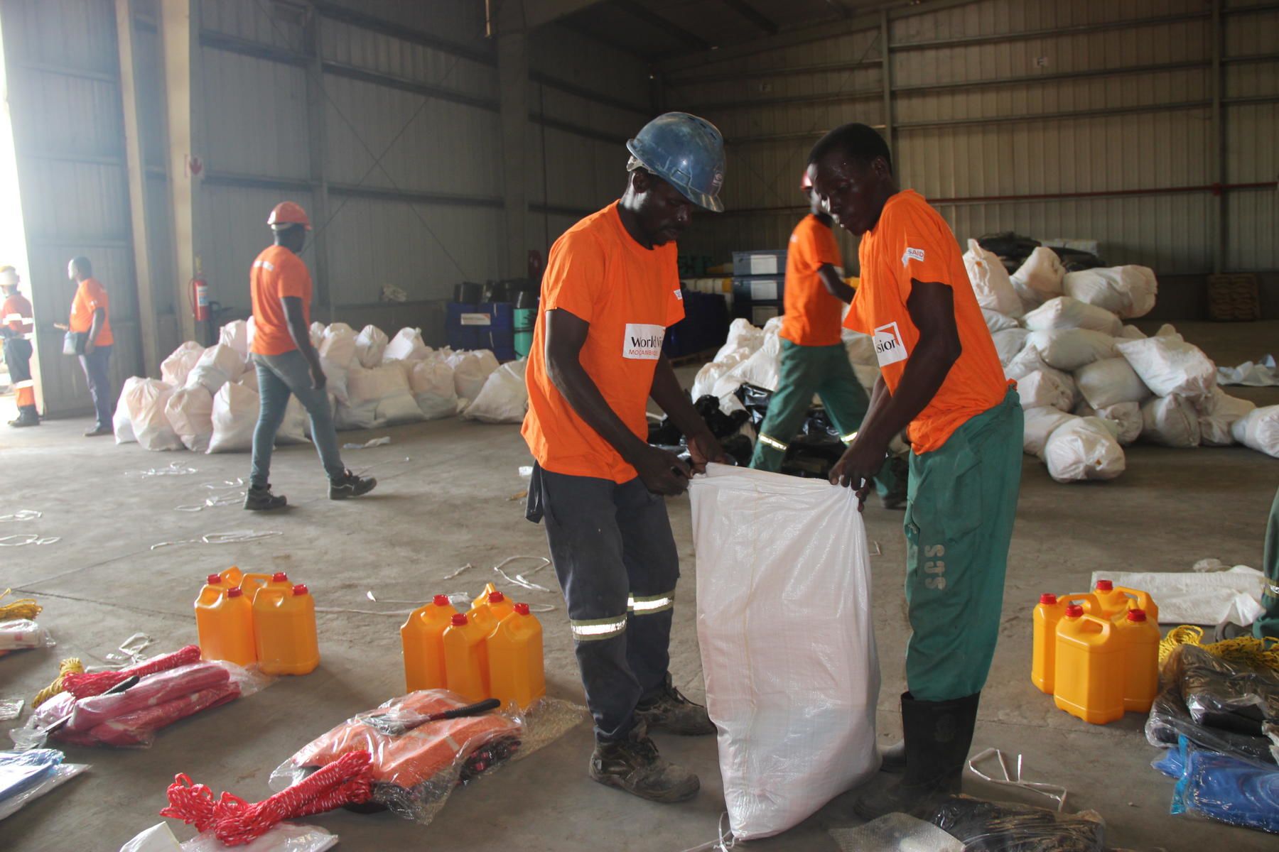 <alt="Emergency response teams helping the communities navigate through the collapsed buildings">