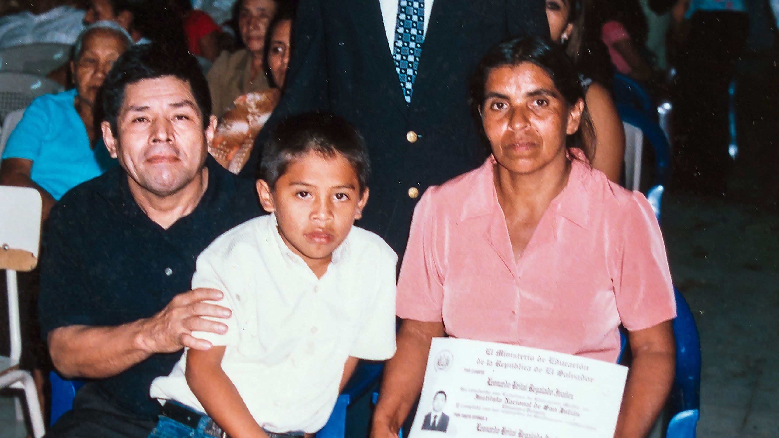 alt="Leonardo, with his parents at his graduation">