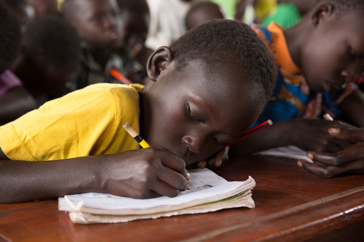 Girl writing in notebook at school
