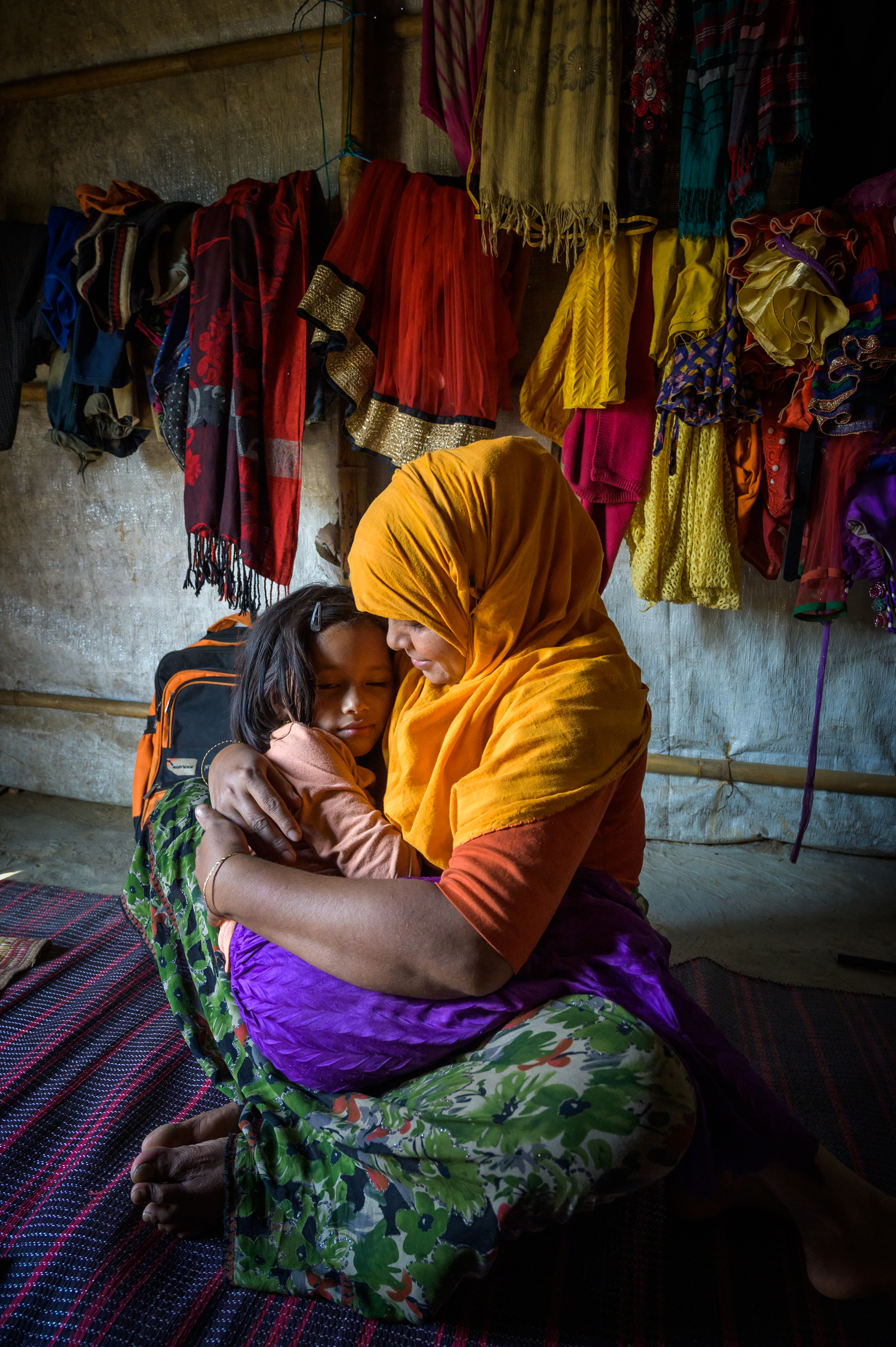 Refugee mother holding and hugging her daughter