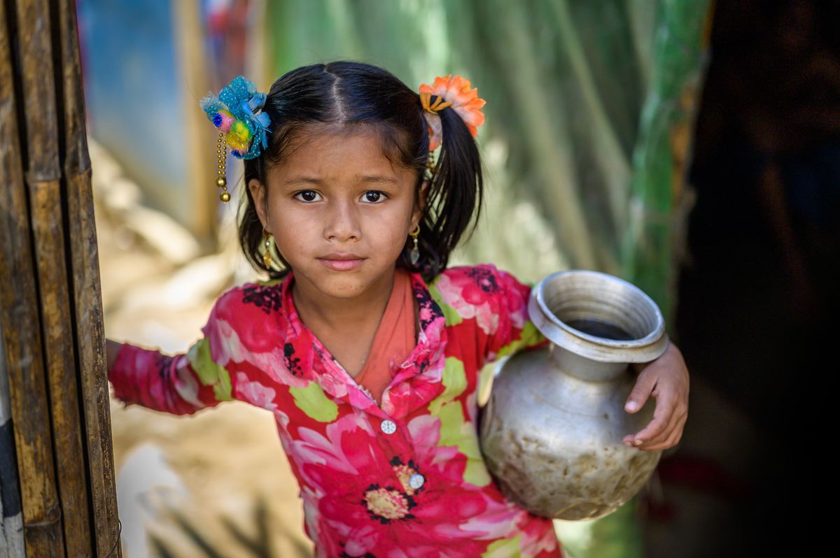 Girl from Bangladesh holding a water basin