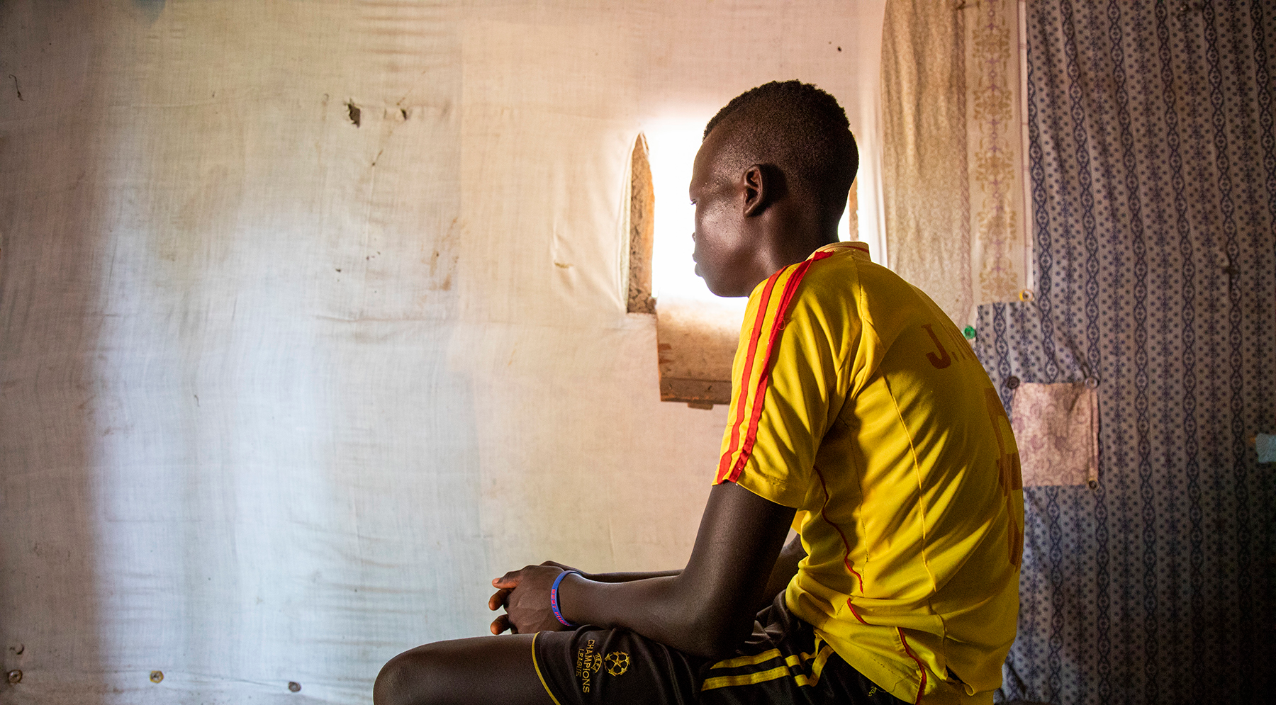 Former child soldier sitting and telling his story