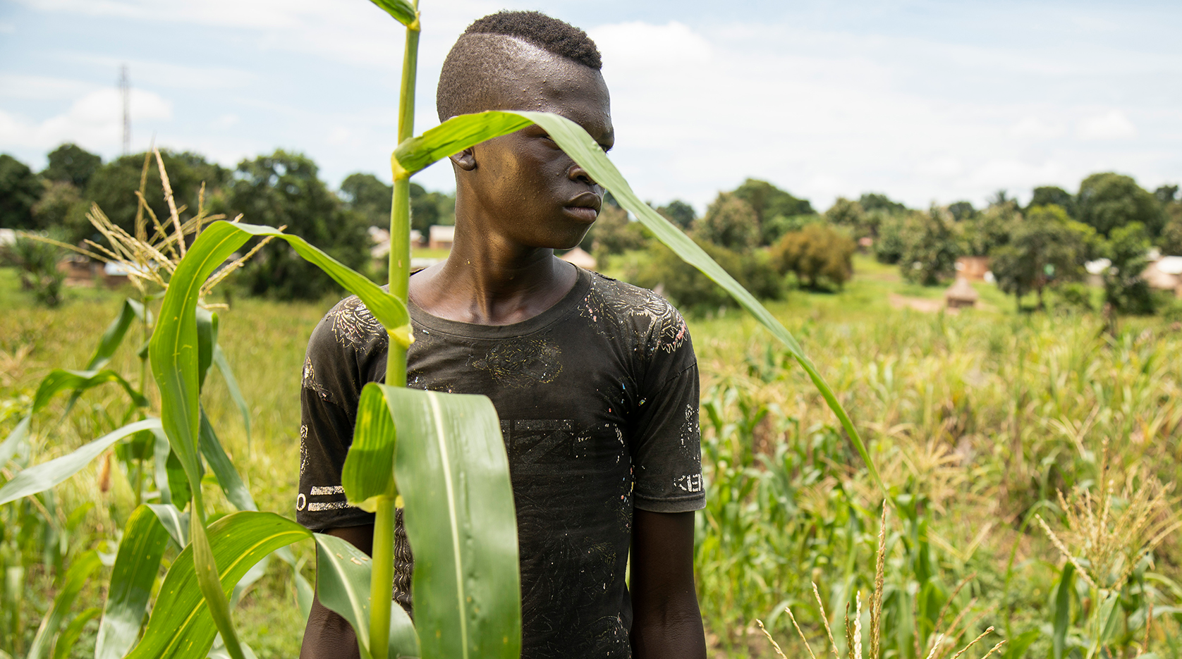 Former child soldier standing in field