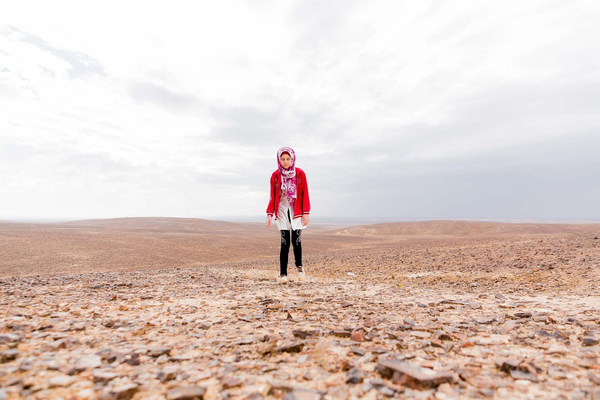 Girl walking in desert.