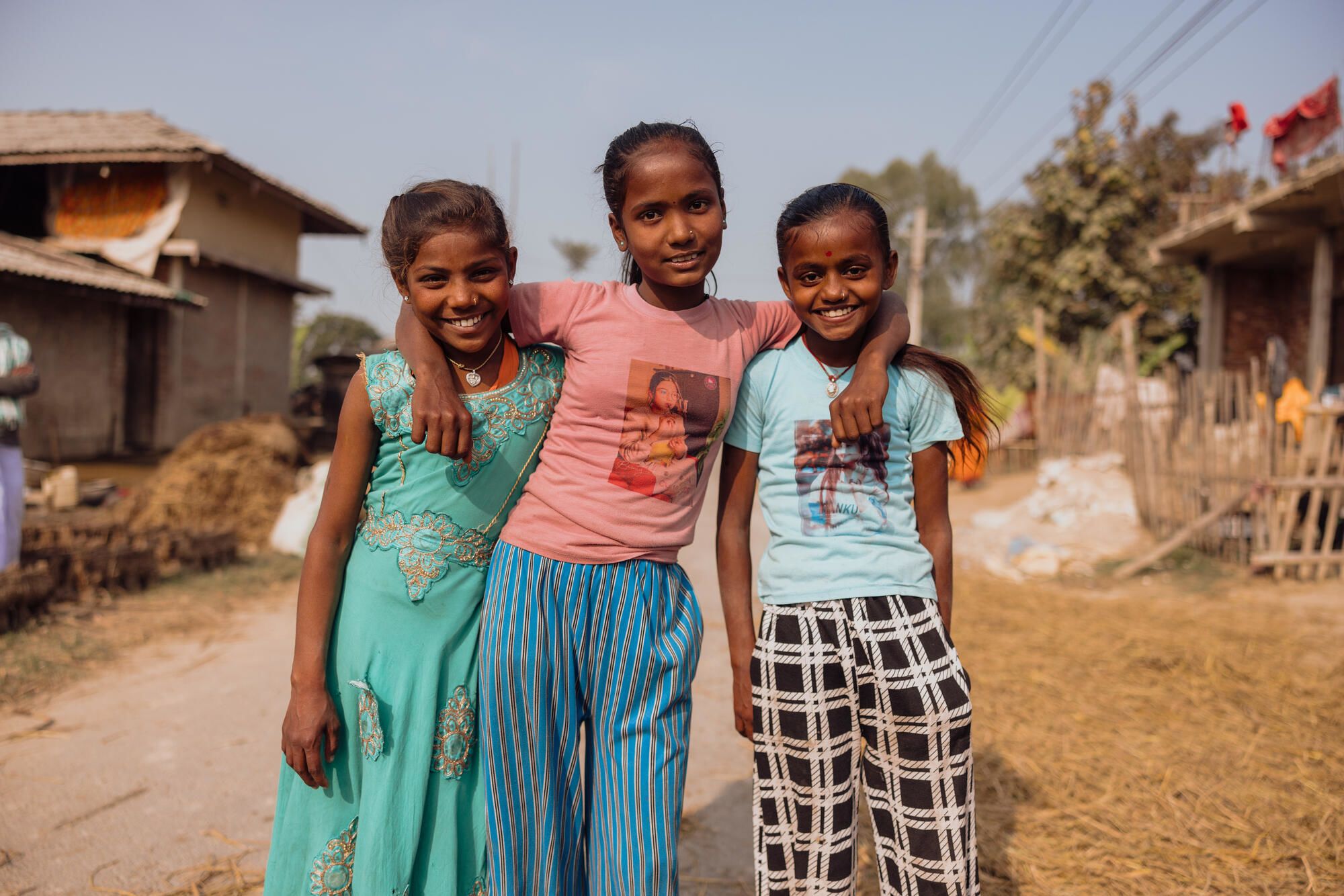 Three young smiling girls posing together