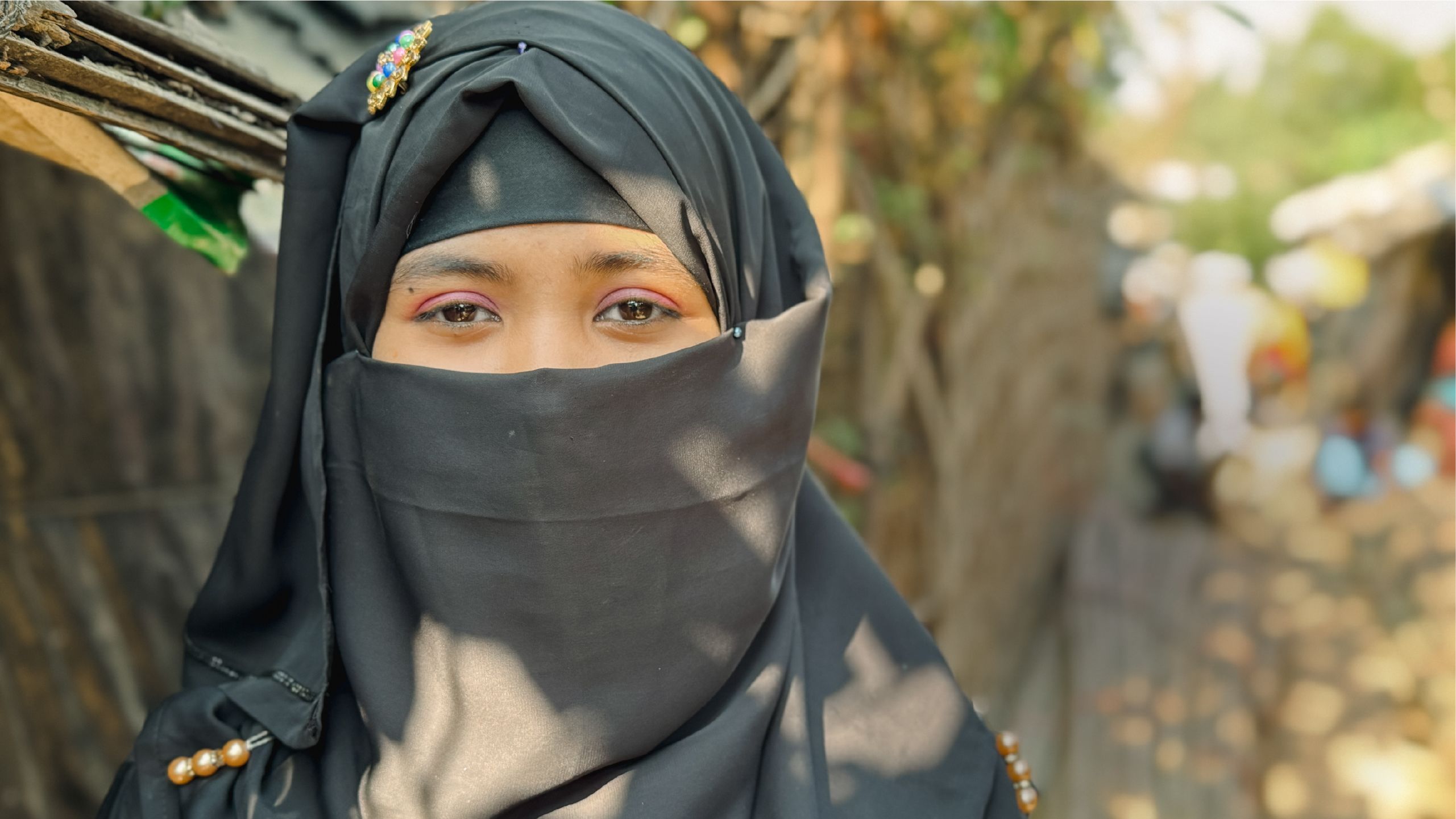 Young girl smiling in traditional head cover