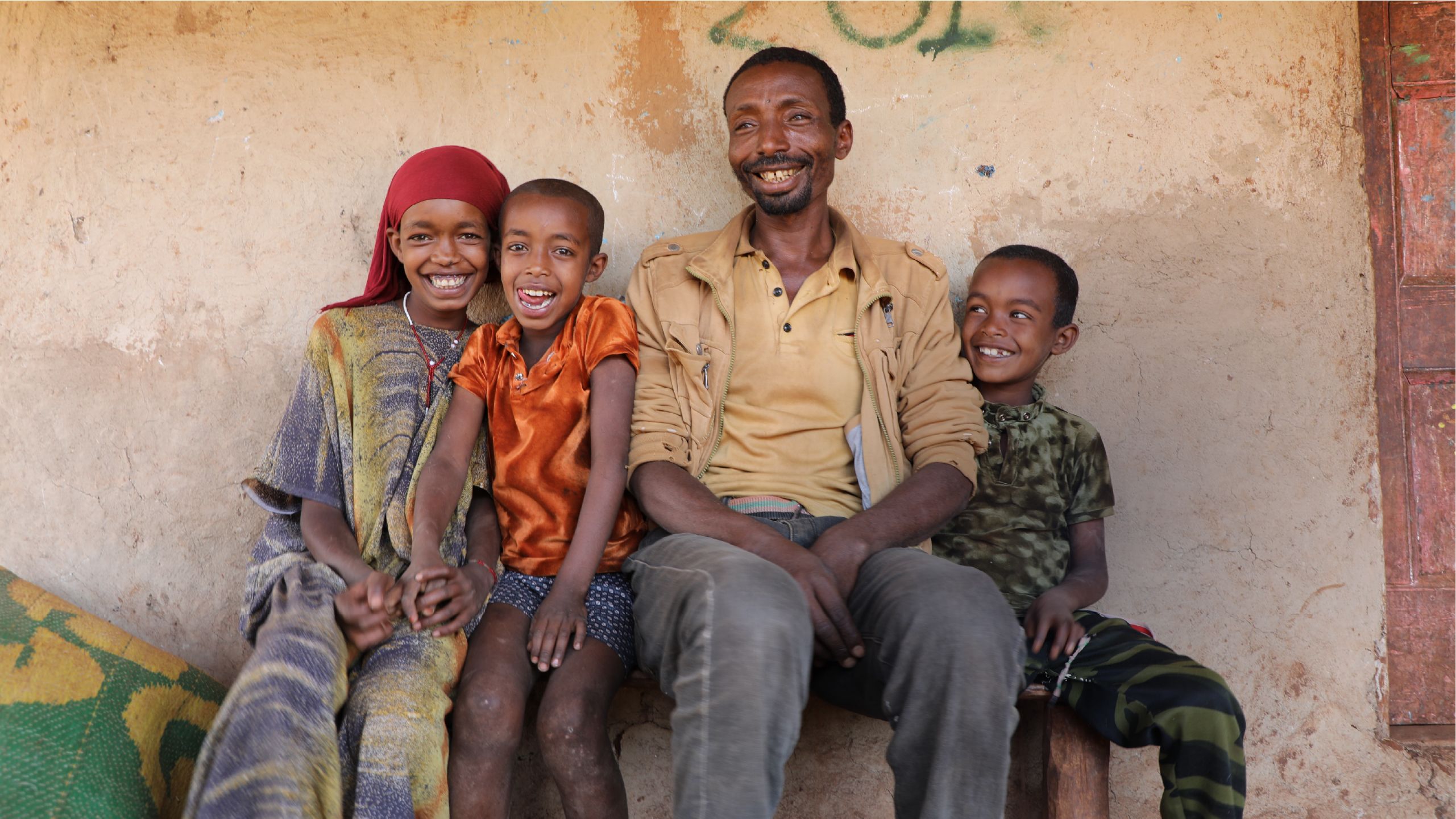 Family photo of father with three happy children