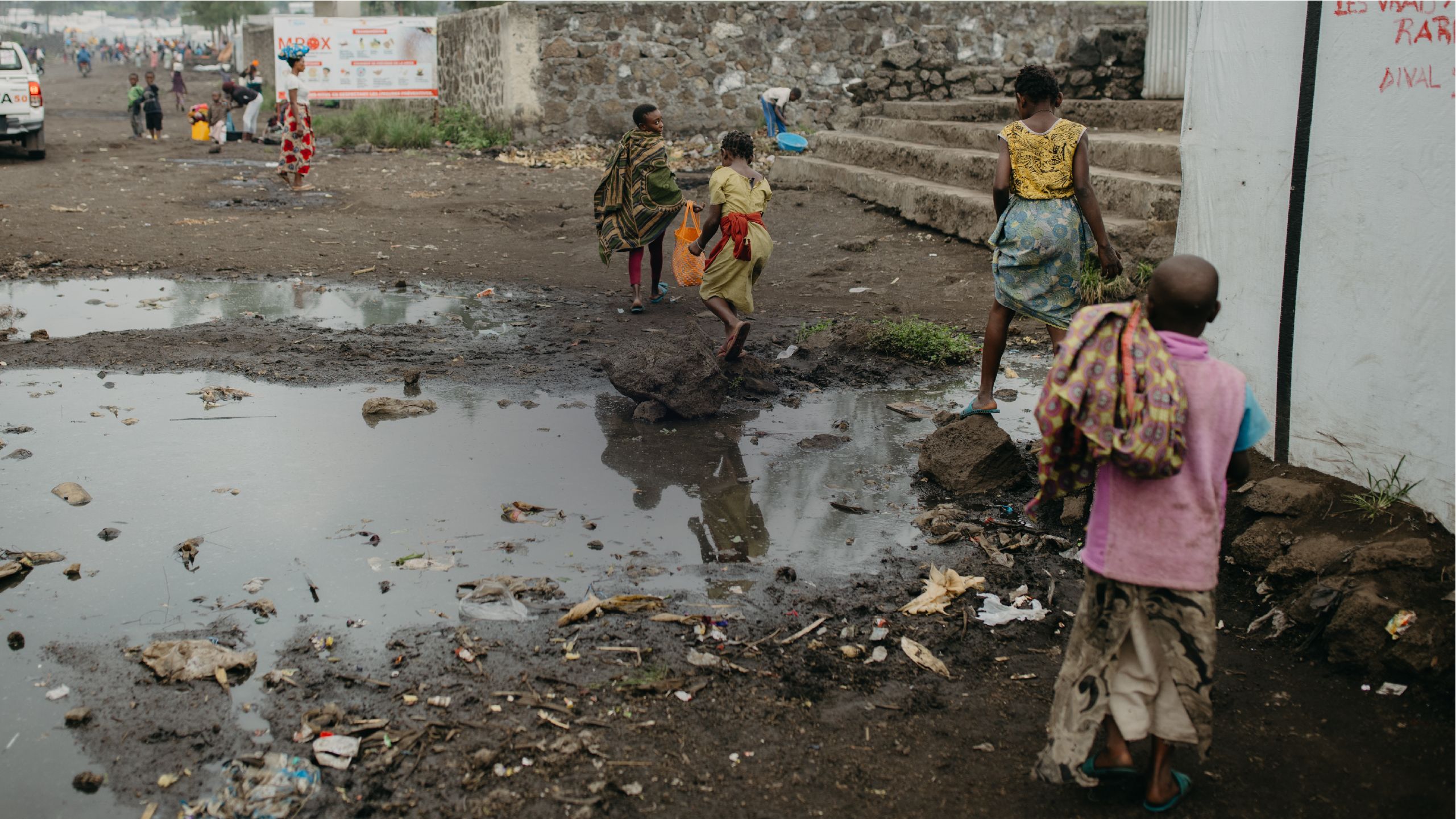 Refugee children walking in camp