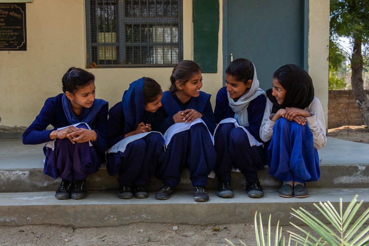 Girls sitting together on a school step