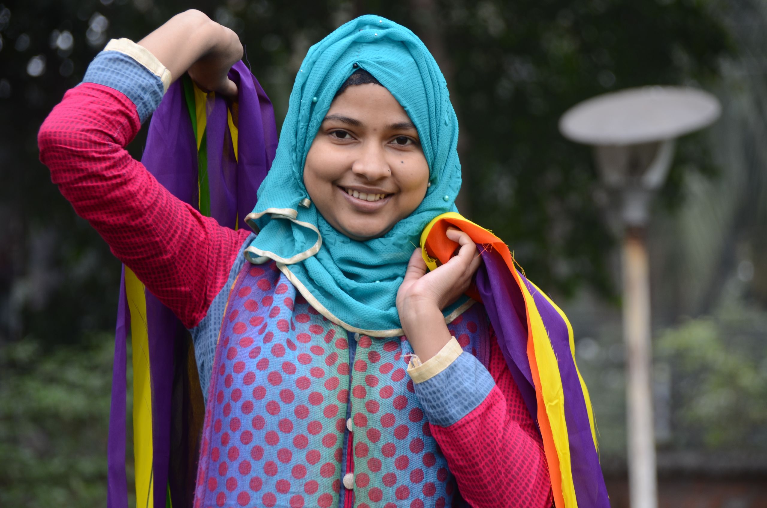 Nasima from Bangladesh holds ribbon
