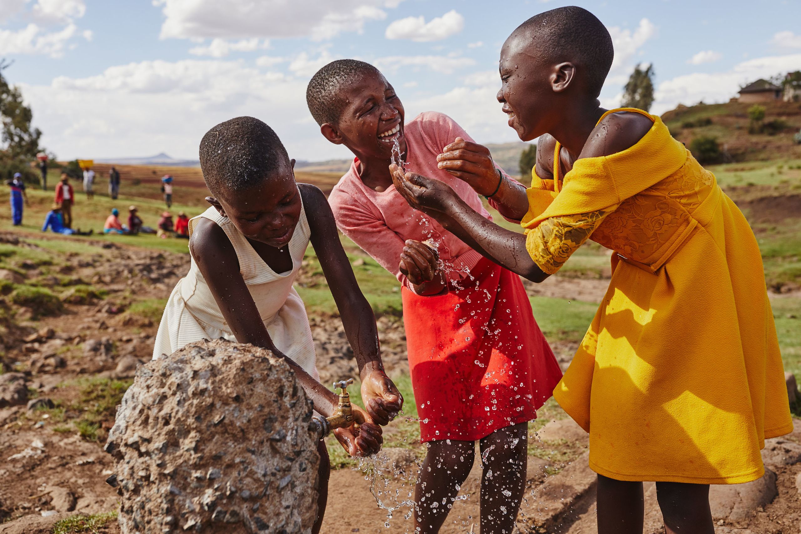 Girls in Lesotho enjoy playing with water