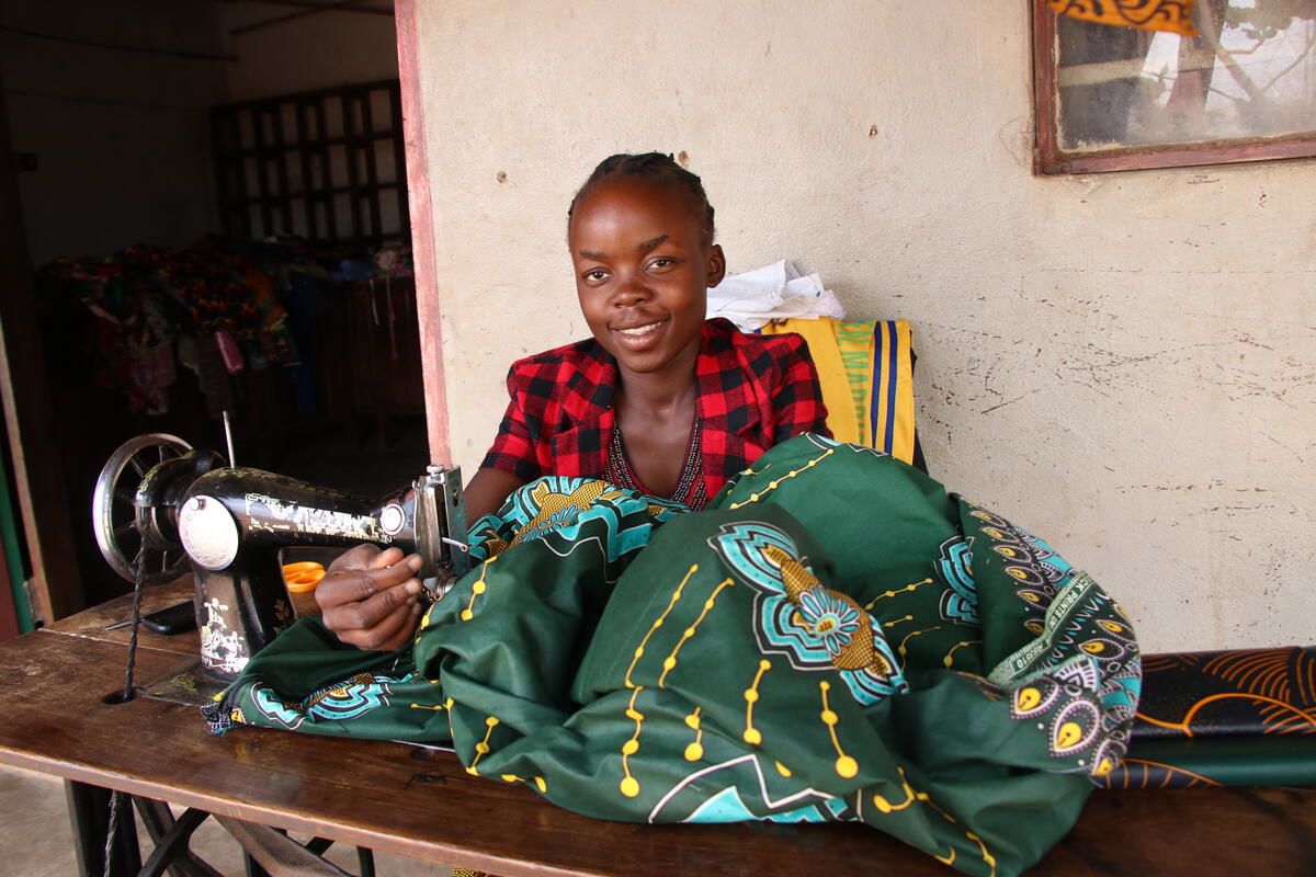 Mwila, sponsored child, sits at the sewing machine in Zambia 