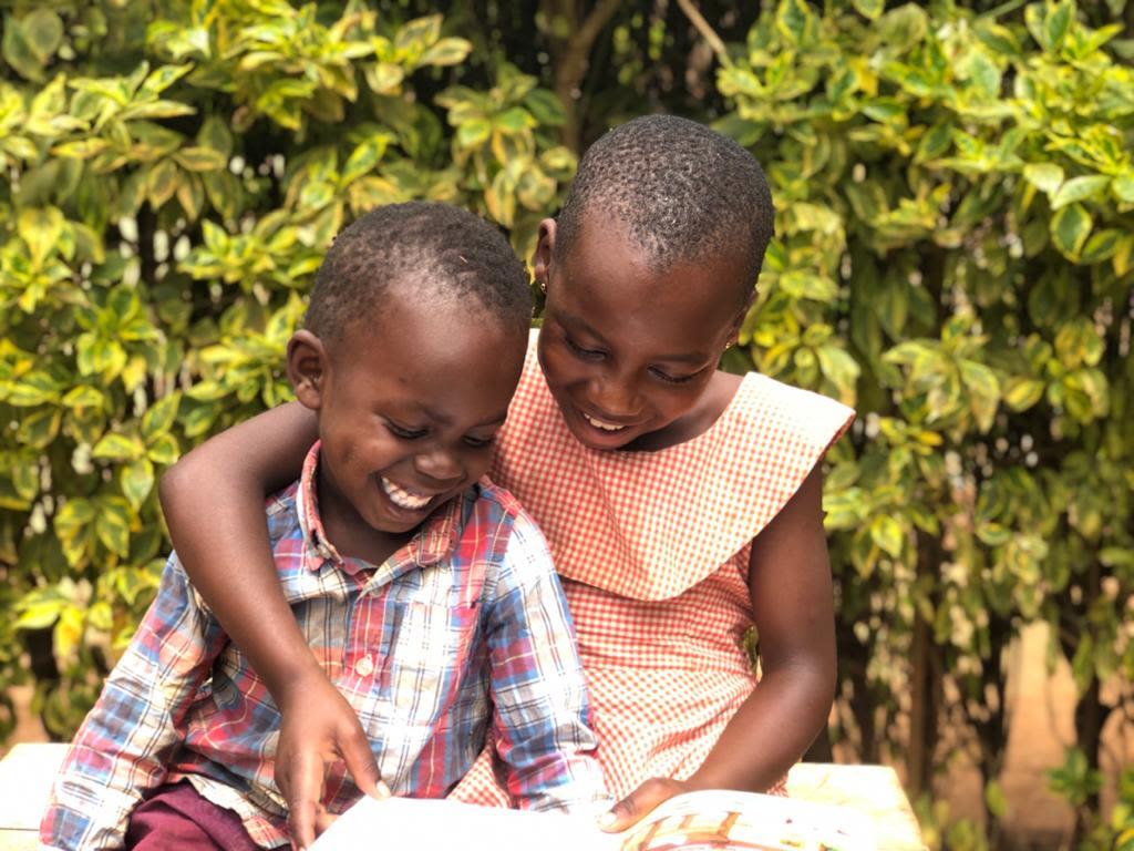 Children in Rwanda enjoy reading a book together