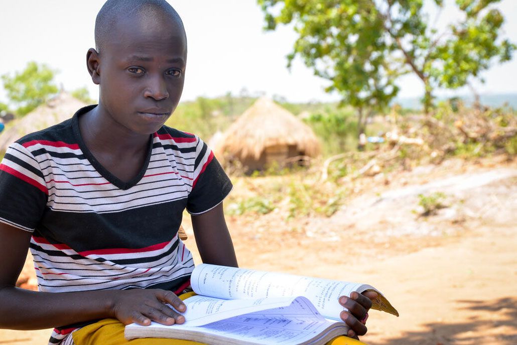 Refugee Child in Uganda studying