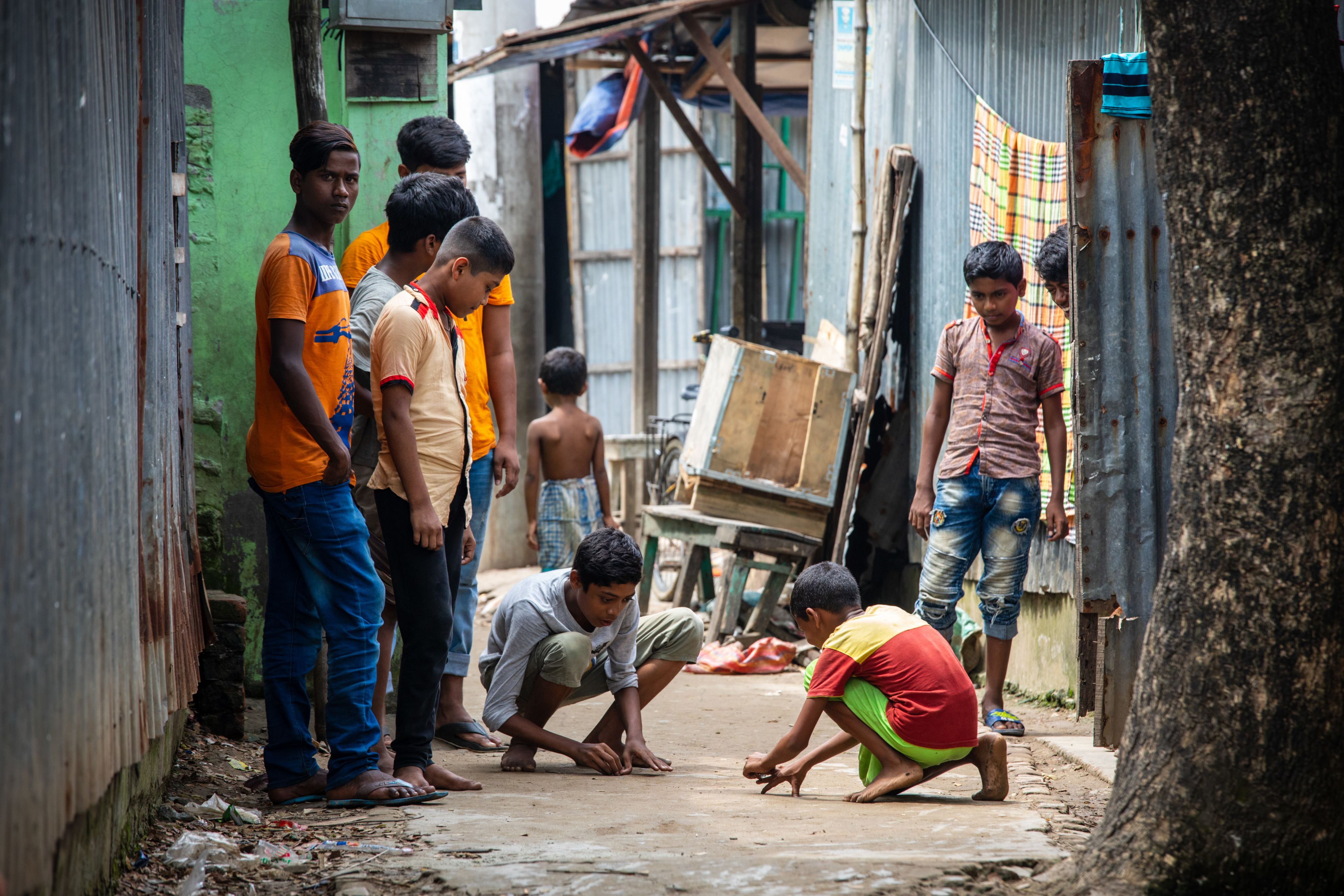 Young boys play in a narrow lane in the streets of Bangladesh