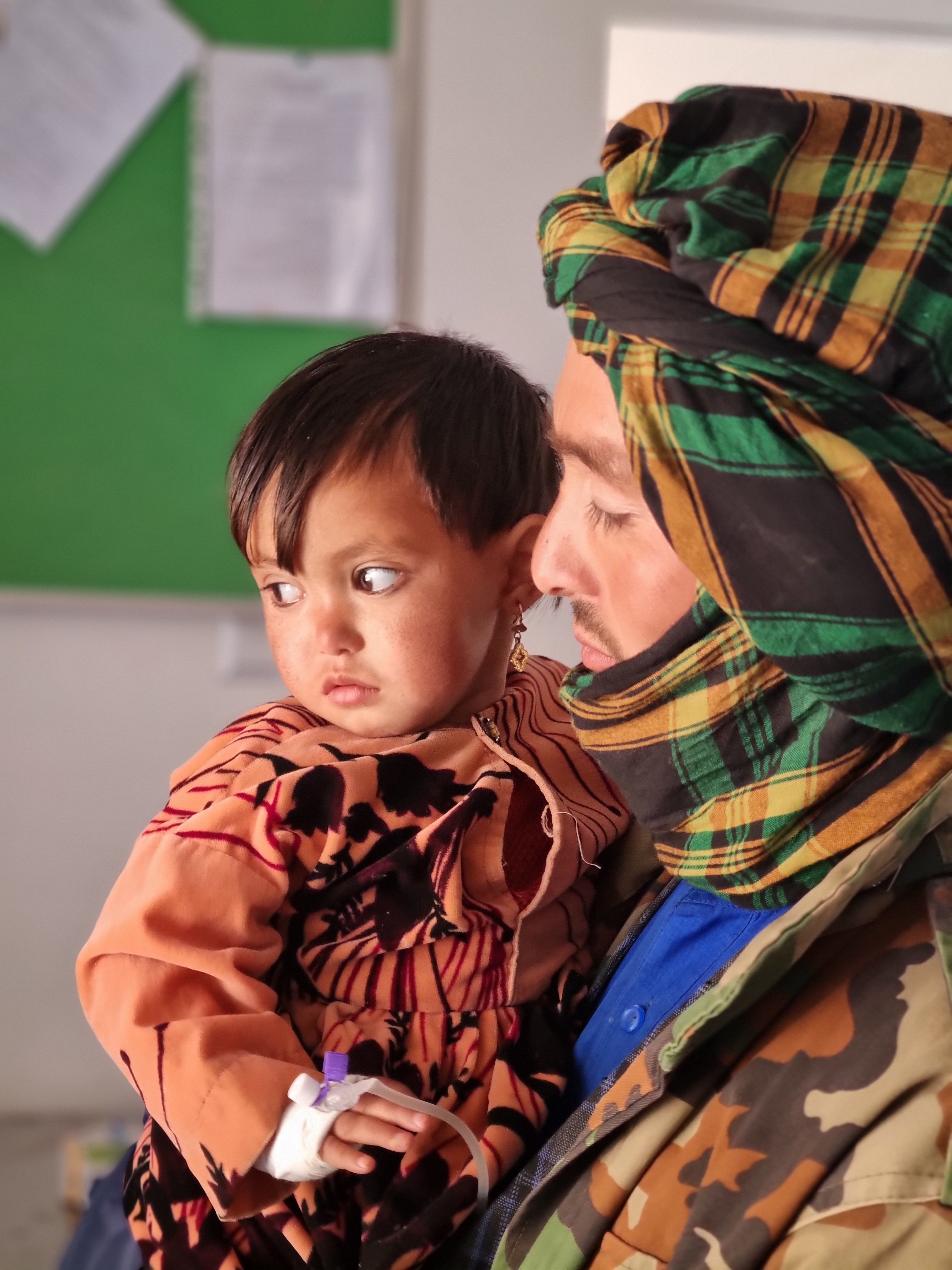 A man holding his toddler daughter.