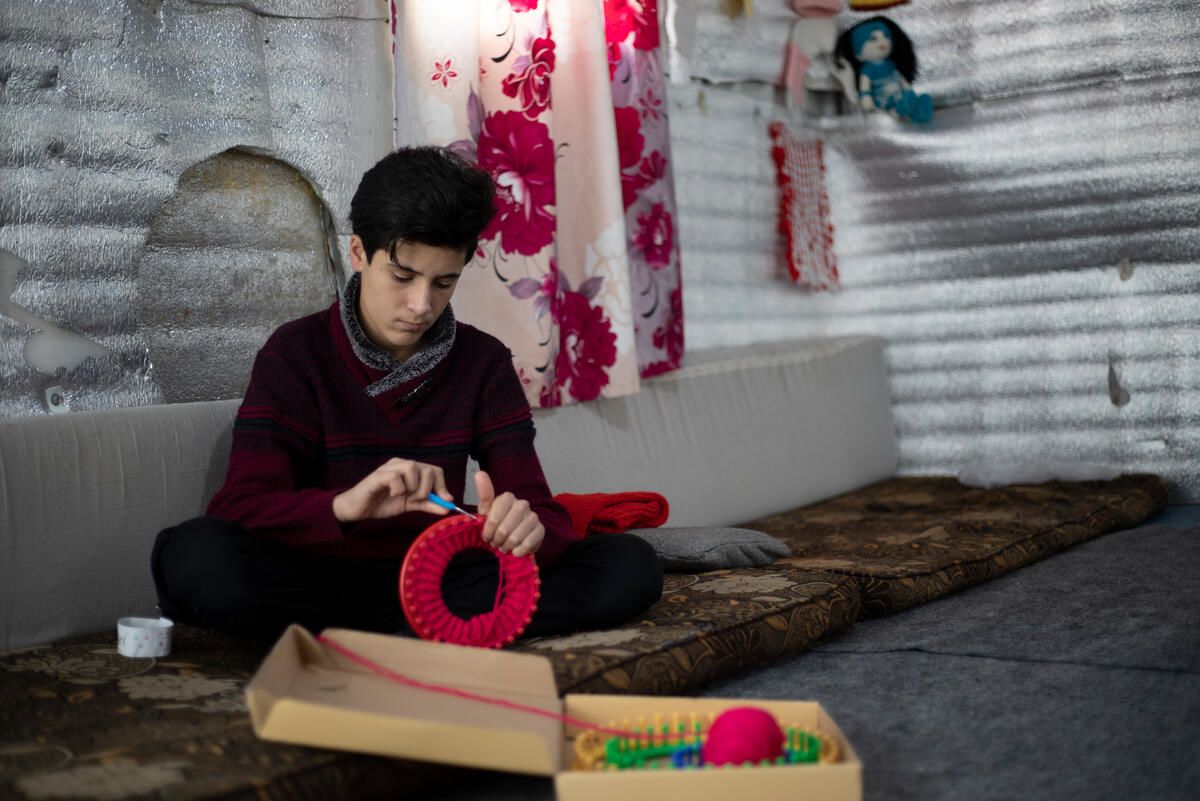 Syrian refugee child in Jordan knits hats and scarves to pass the time and help his neighbours
