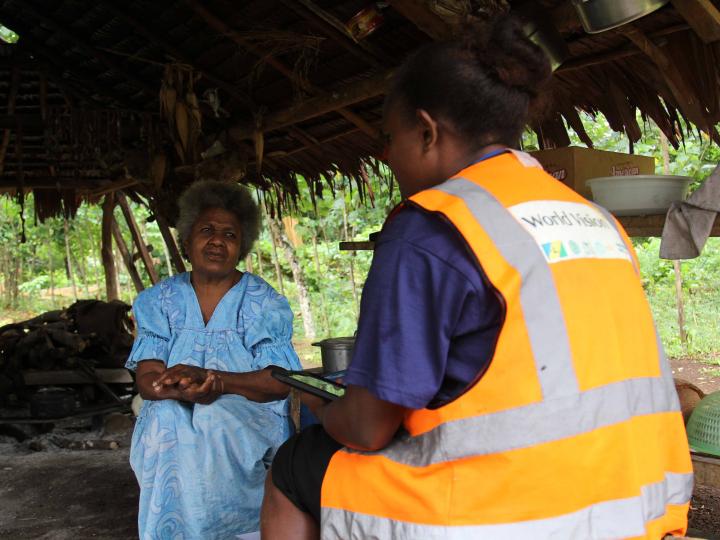 A World Vision enumerator speaking to community member as part of the water, women and disability study