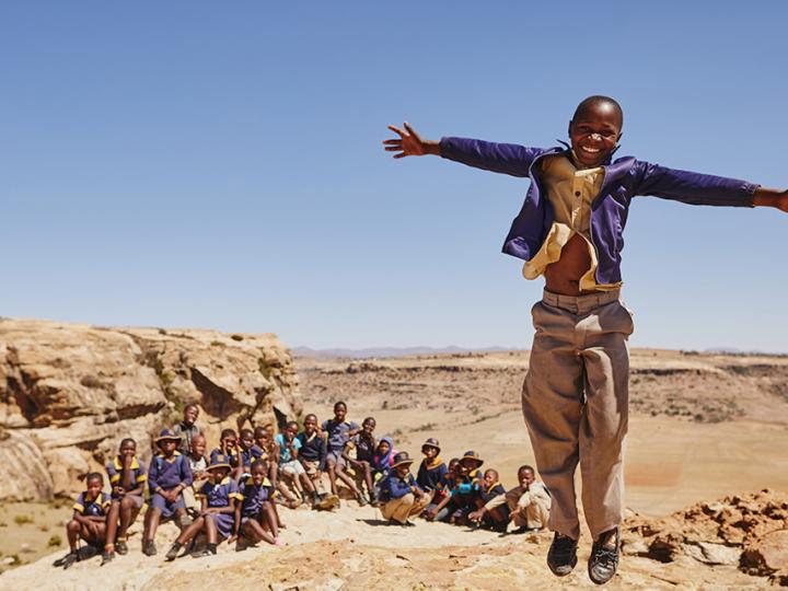 Boy jumping with his arms open