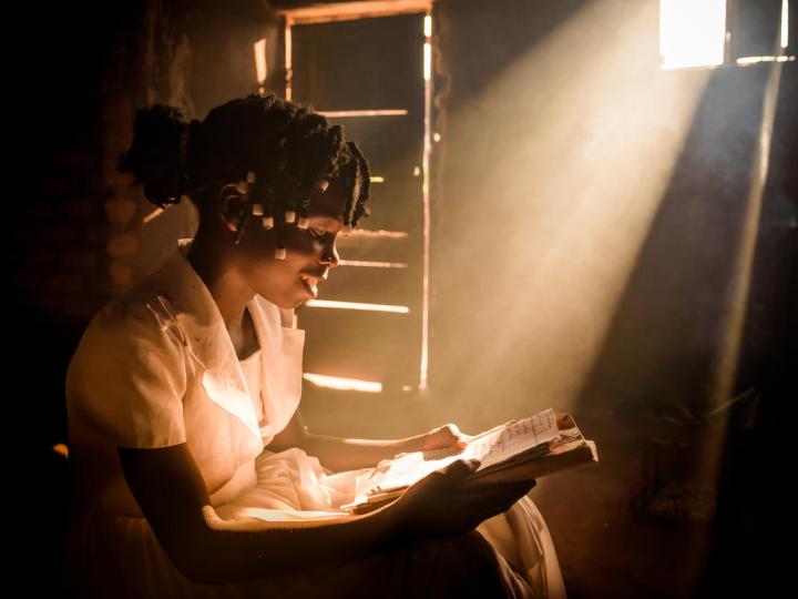 Girl reading in her home with light