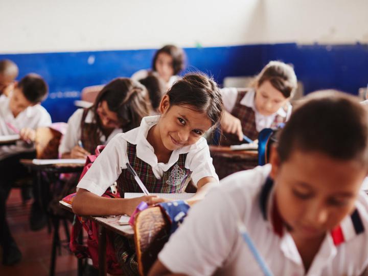Children learn at desks in school in Colombia
