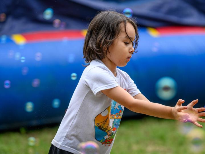 child plays with bubbles