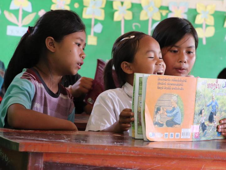 Children read a book together