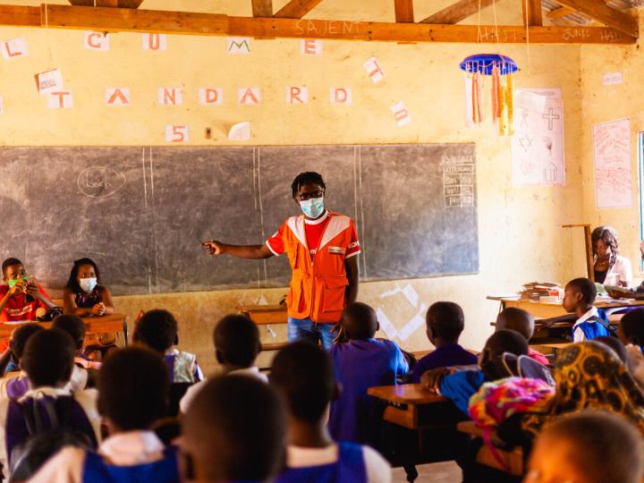 WVI staff member teaches classroom full of children