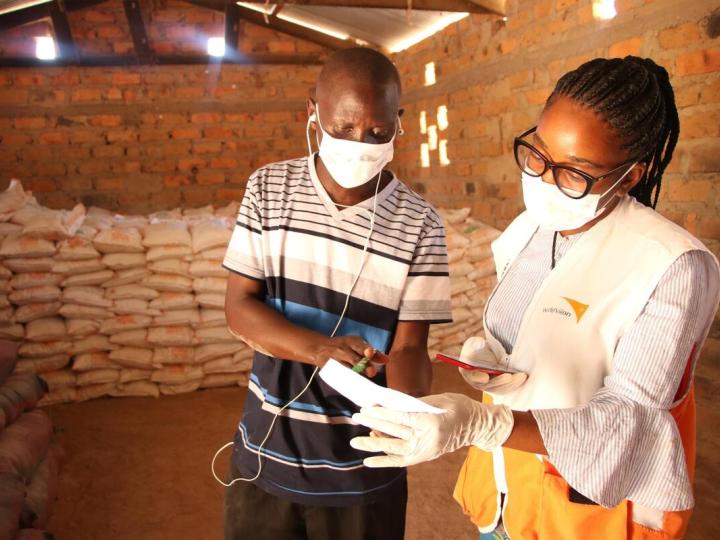 World Vision staff speaks with man 