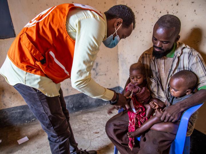 Father helps his children receive healthcare