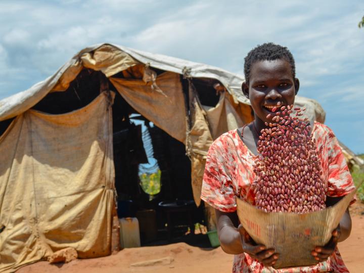 Woman in refugee camp with grain 
