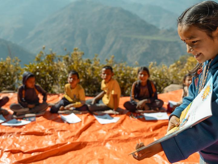 A girl reads book at a Reading Camp