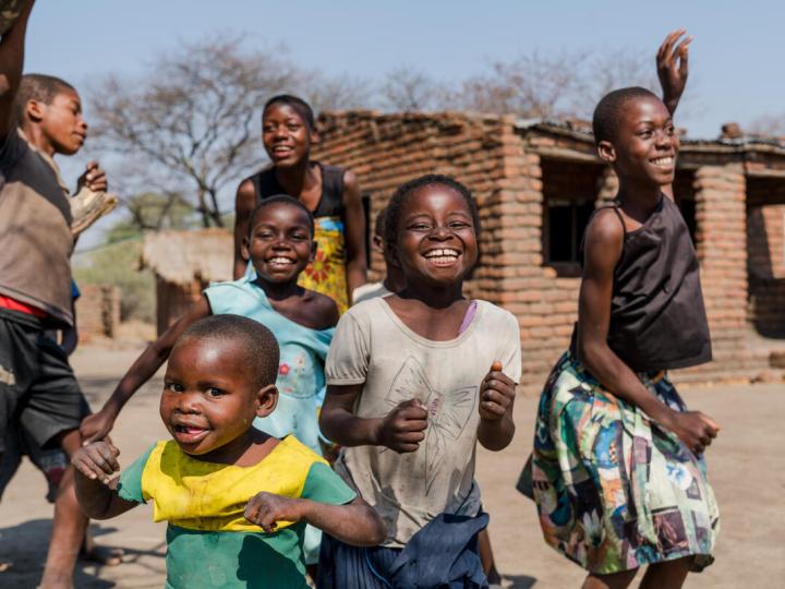 Children play happily outside Nored's home